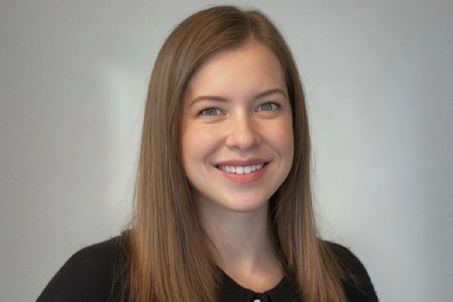 young woman in black shirt with blonde hair smiling